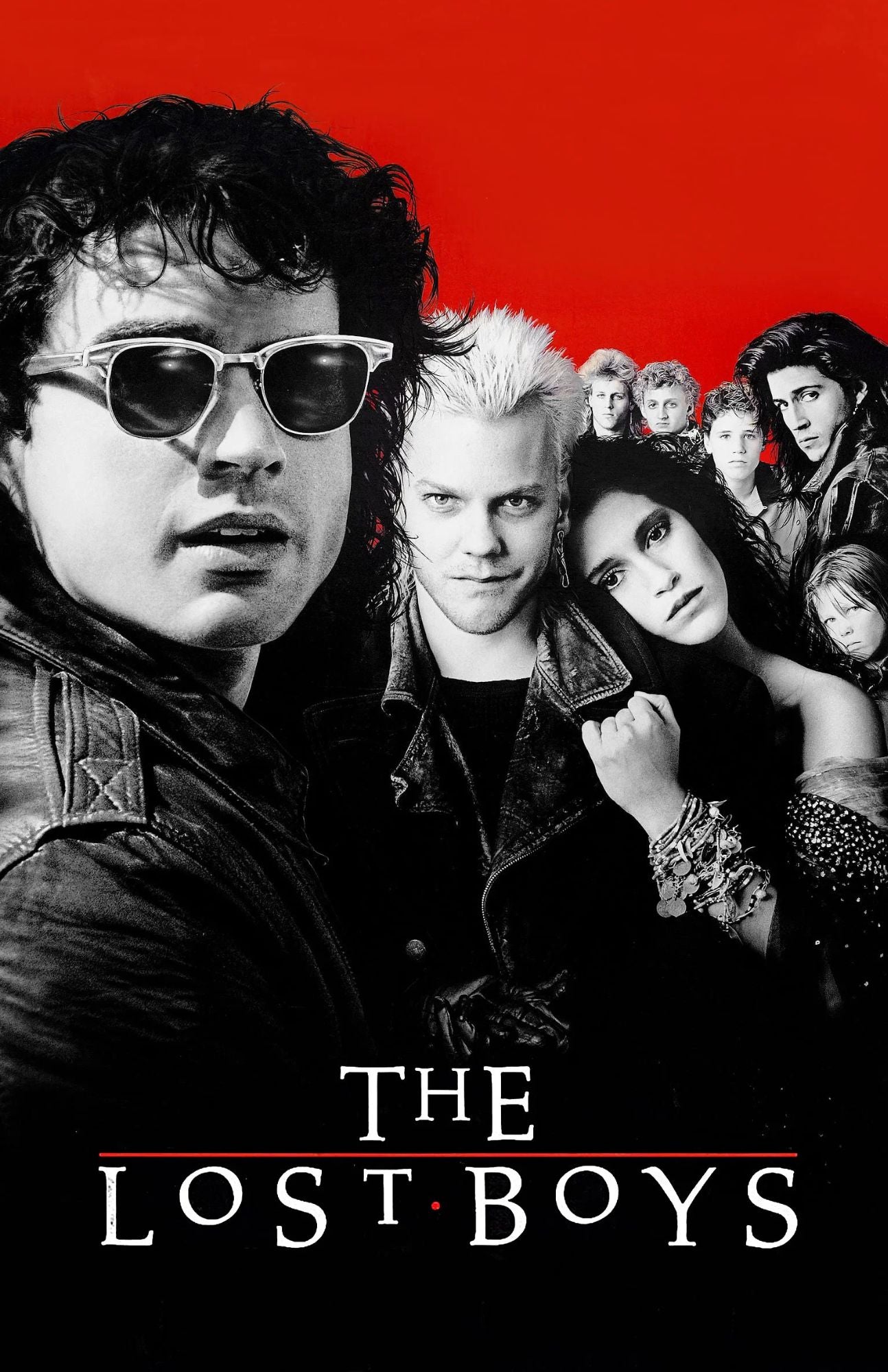 The Lost Boys movie poster featuring the cast in black and white against a bold red background, with the title 'THE LOST BOYS' at the bottom.